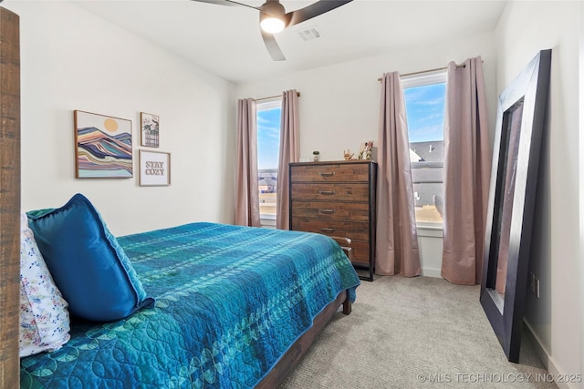 bedroom with carpet flooring, visible vents, and a ceiling fan