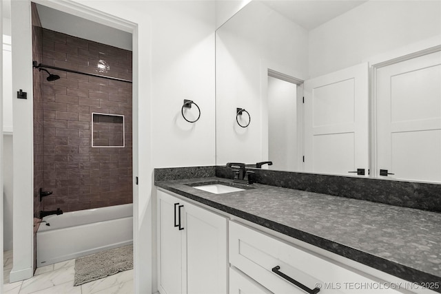 full bathroom featuring marble finish floor, vanity, and bathing tub / shower combination