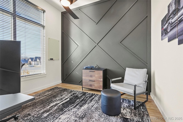 living area featuring baseboards and wood finished floors