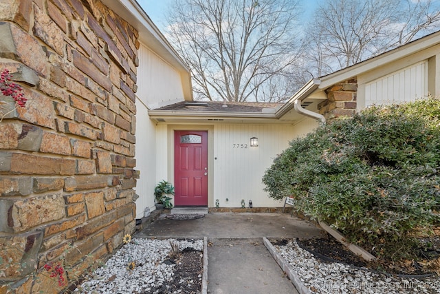 doorway to property featuring stone siding