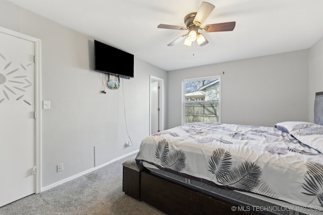 carpeted bedroom featuring baseboards and a ceiling fan