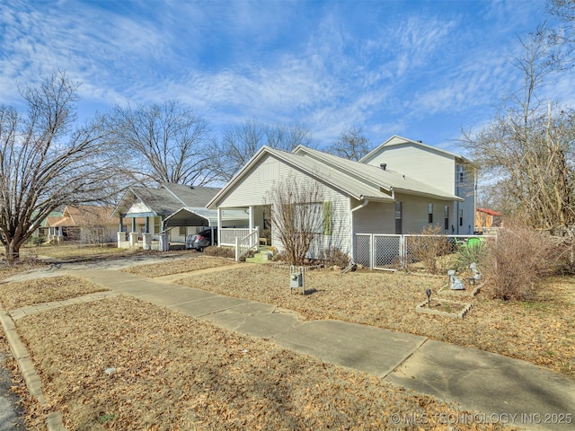 view of front facade featuring driveway, a porch, and a carport