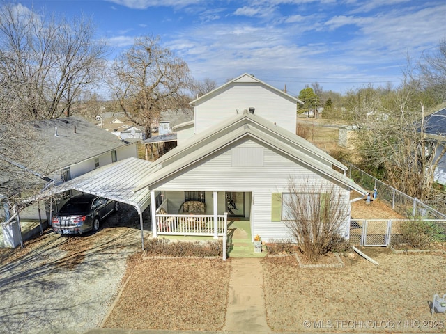 view of front of home with a porch, a gate, fence, a carport, and driveway