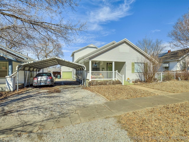 view of front of house with covered porch, a carport, and driveway