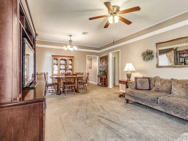 carpeted living room with baseboards, visible vents, crown molding, and ceiling fan with notable chandelier