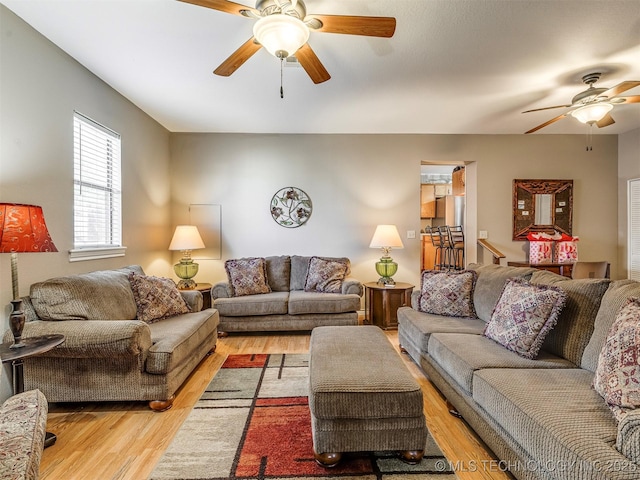 living room featuring ceiling fan and wood finished floors