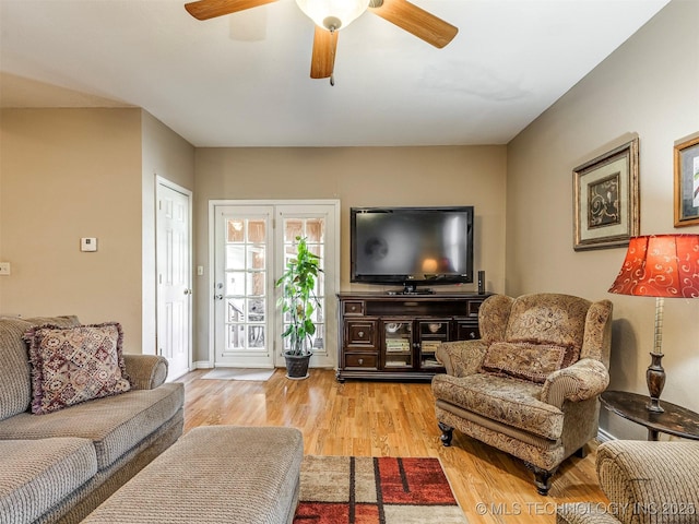 living room featuring ceiling fan and wood finished floors