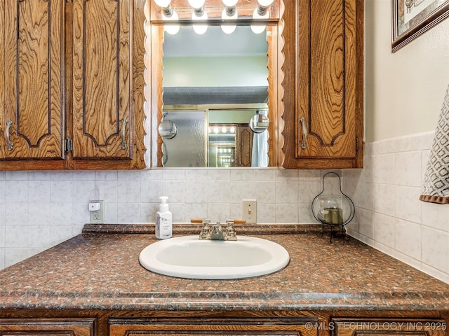 interior space featuring brown cabinetry, dark countertops, and a sink