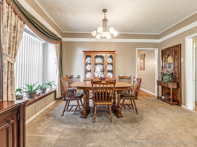 dining area with light carpet, ornamental molding, baseboards, and a notable chandelier