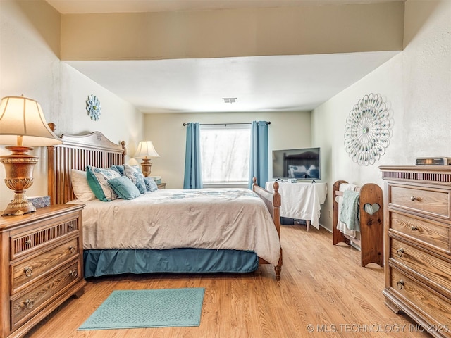 bedroom featuring light wood-type flooring and visible vents