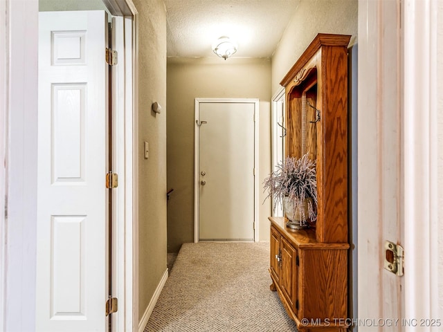 corridor featuring carpet floors and baseboards