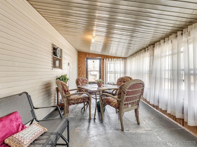 sunroom / solarium featuring vaulted ceiling