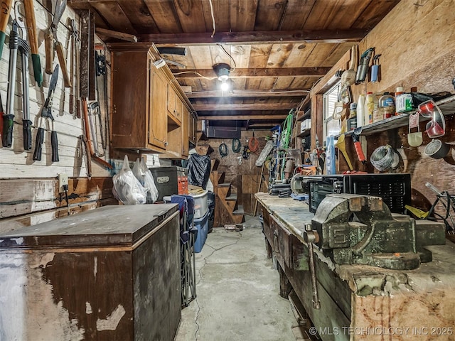 miscellaneous room with wooden ceiling, concrete floors, and a workshop area