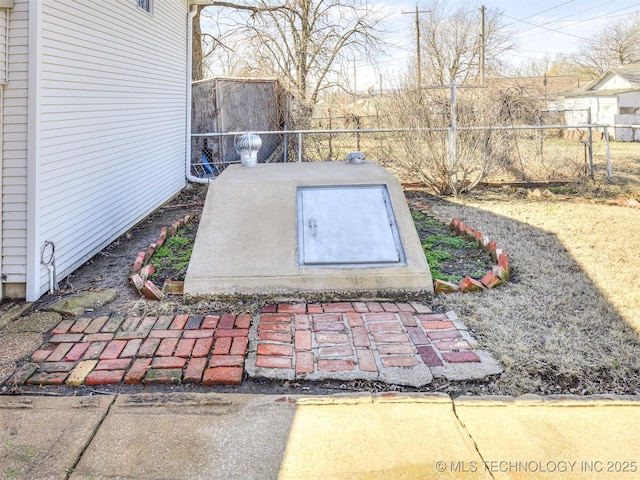 view of storm shelter with fence