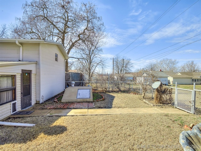 view of yard with fence and a gate