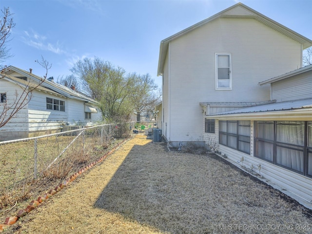 view of home's exterior with central AC unit and fence