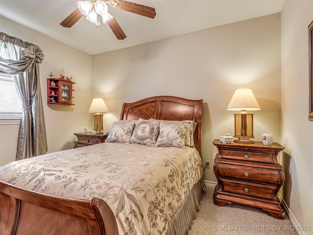 bedroom with ceiling fan, carpet flooring, and baseboards