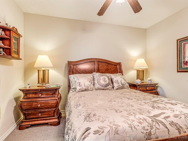 carpeted bedroom with a ceiling fan and baseboards