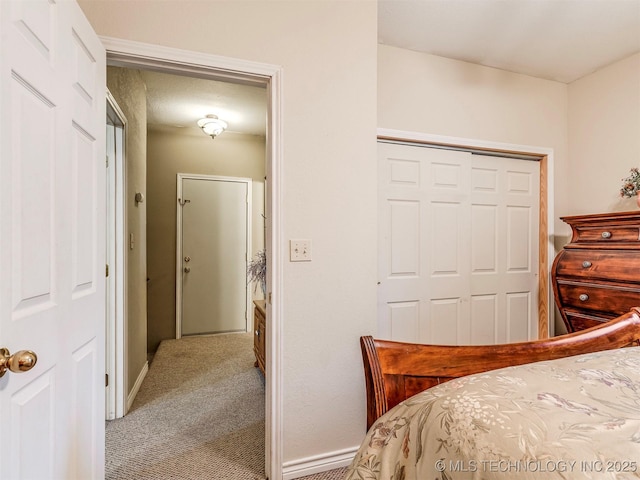 bedroom featuring a closet, carpet, and baseboards