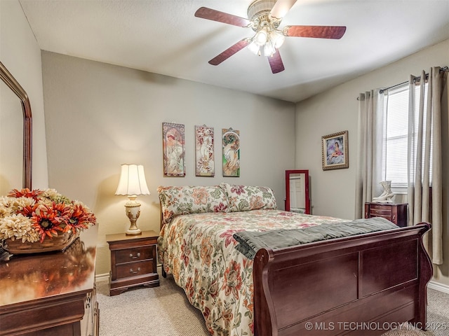 bedroom featuring light carpet, ceiling fan, and baseboards