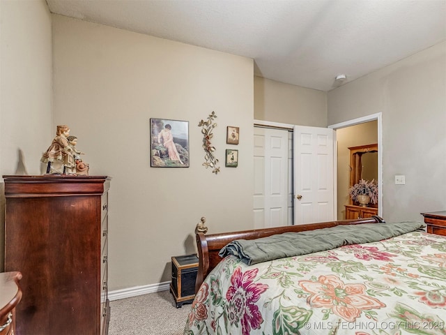 bedroom with a closet, baseboards, and carpet flooring