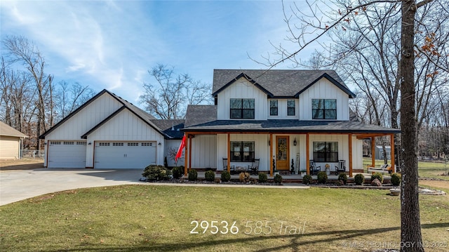 modern farmhouse featuring covered porch, board and batten siding, a front yard, a garage, and driveway