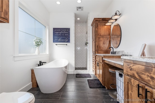 full bath featuring a stall shower, visible vents, vanity, and wood finish floors