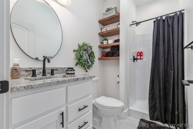 bathroom featuring a stall shower, vanity, and toilet