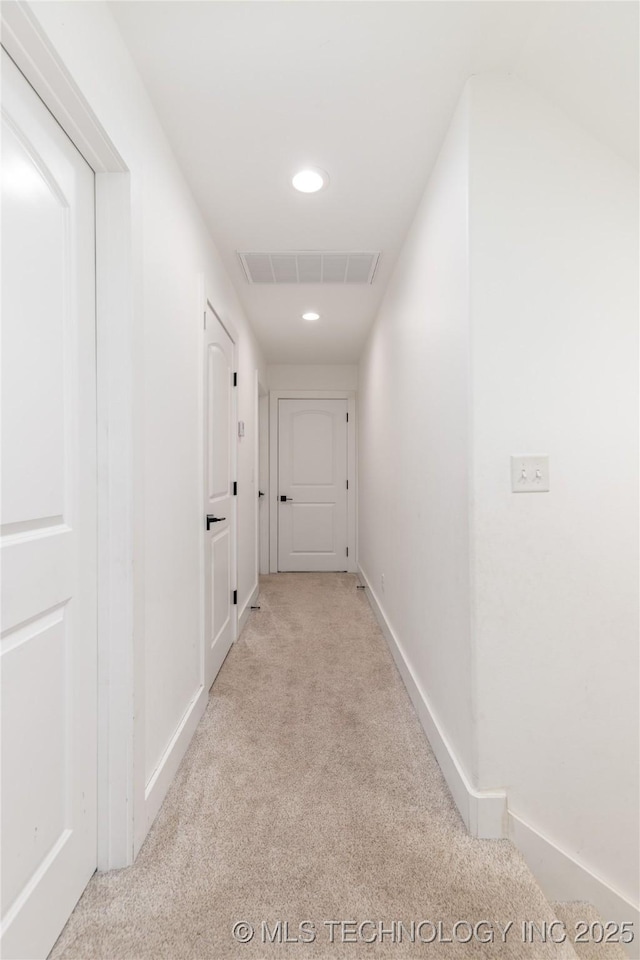 corridor with baseboards, recessed lighting, visible vents, and light colored carpet