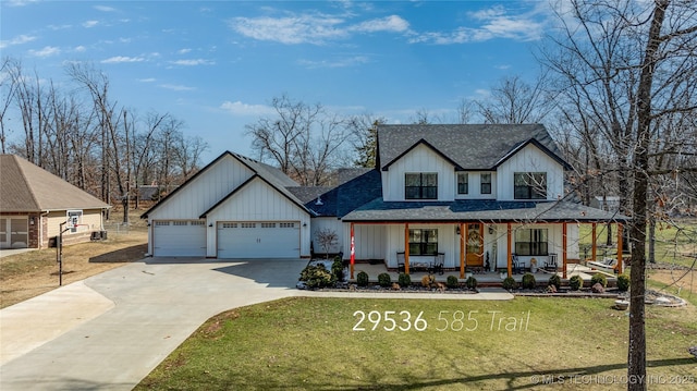 modern farmhouse featuring a porch, a front yard, and roof with shingles