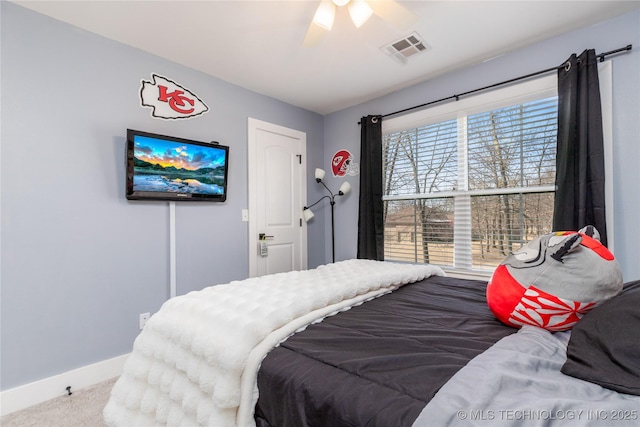 carpeted bedroom with baseboards, visible vents, and ceiling fan