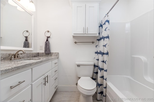 bathroom featuring toilet, baseboards, shower / tub combo with curtain, and vanity