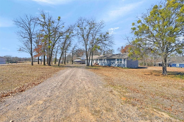 view of street with dirt driveway