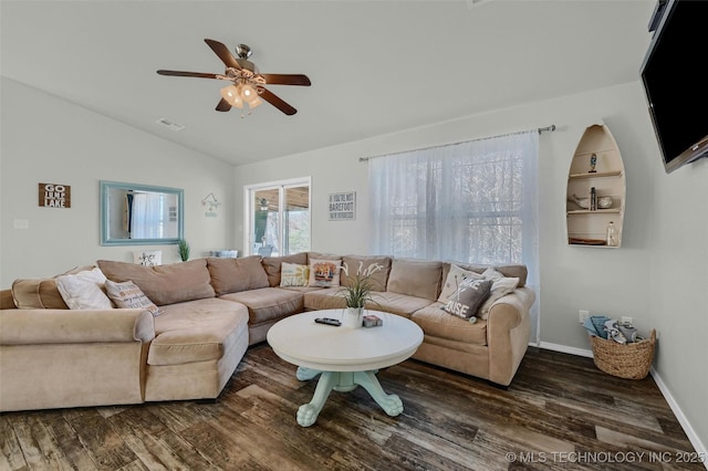 living area featuring vaulted ceiling, ceiling fan, wood finished floors, and baseboards