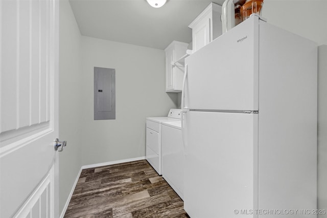 washroom featuring cabinet space, electric panel, baseboards, dark wood-type flooring, and washer and dryer