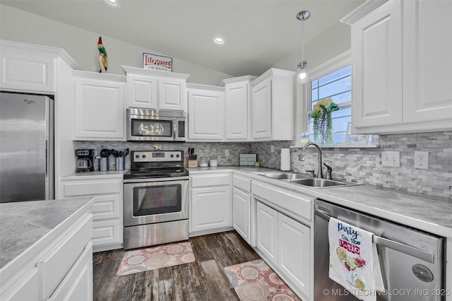 kitchen featuring white cabinets, stainless steel appliances, and a sink