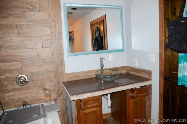 bathroom featuring vanity and a tub