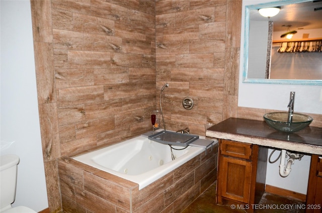 bathroom featuring toilet, a combined bath / shower with jetted tub, and vanity