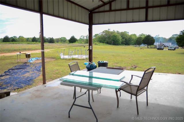 view of patio / terrace featuring outdoor dining space and a rural view