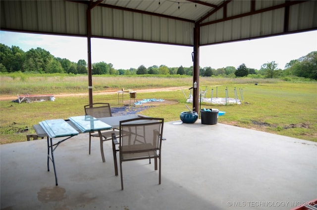 view of patio / terrace with outdoor dining area and a rural view