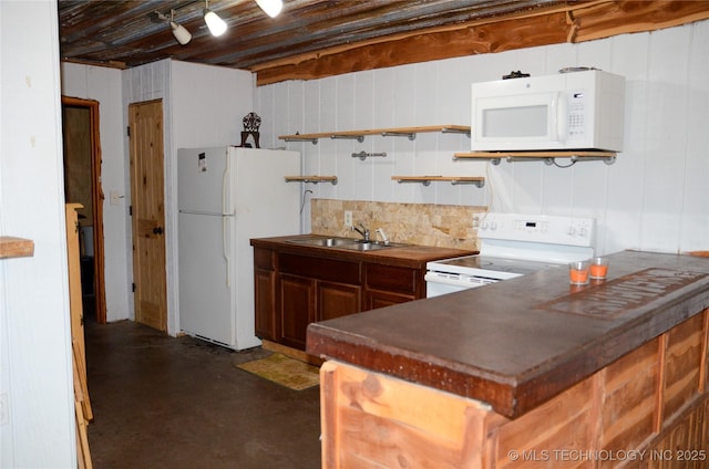 kitchen with white appliances, concrete floors, a sink, backsplash, and dark countertops