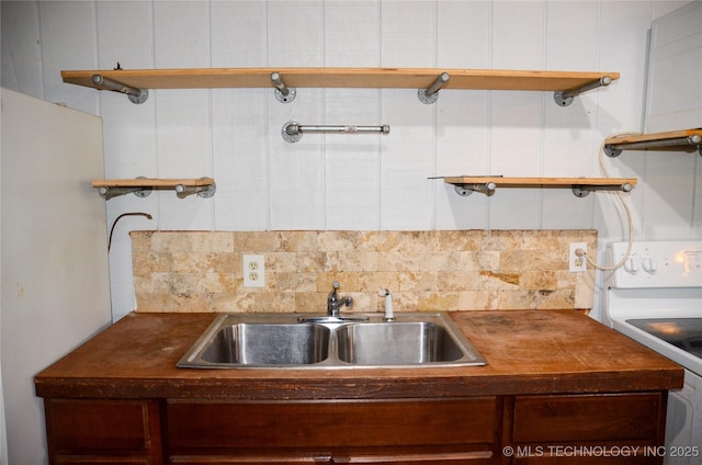 kitchen featuring backsplash, white electric stove, open shelves, and a sink