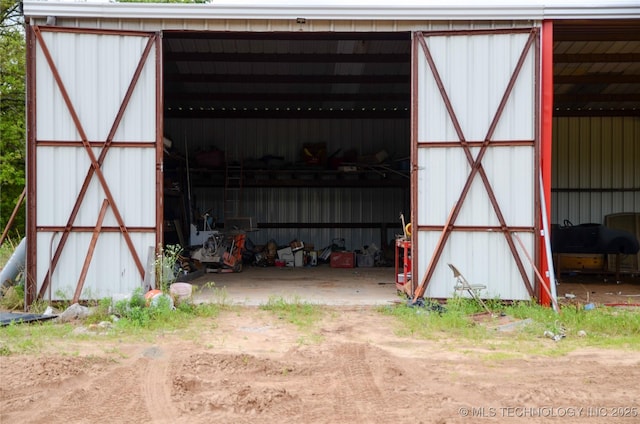 view of pole building featuring dirt driveway