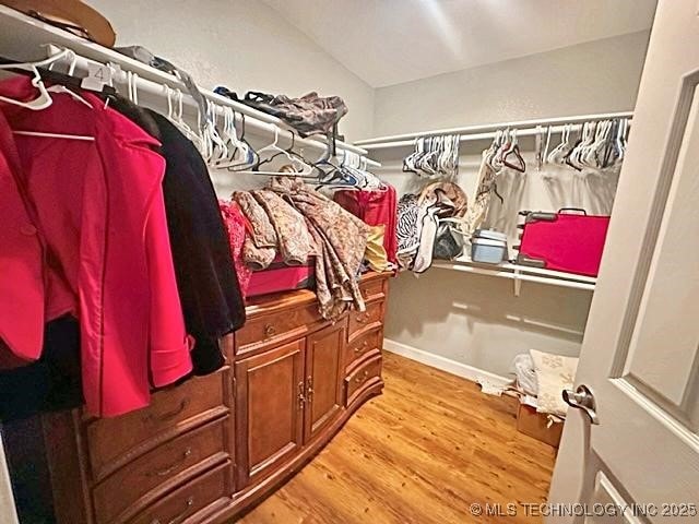 walk in closet featuring light wood finished floors