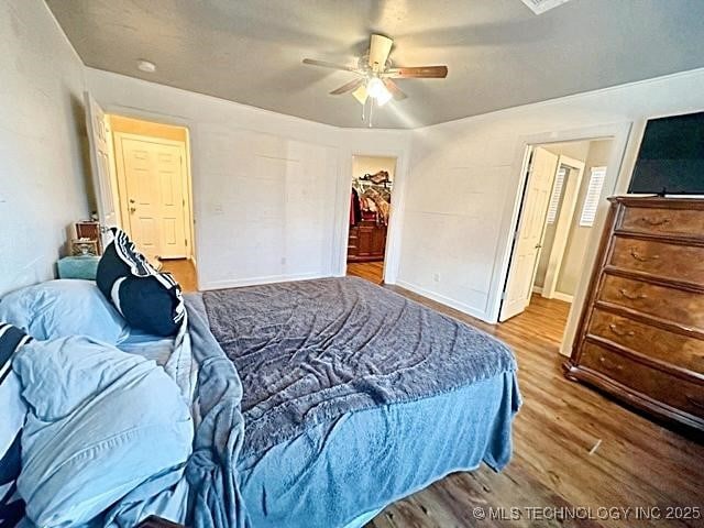 bedroom with ceiling fan and wood finished floors