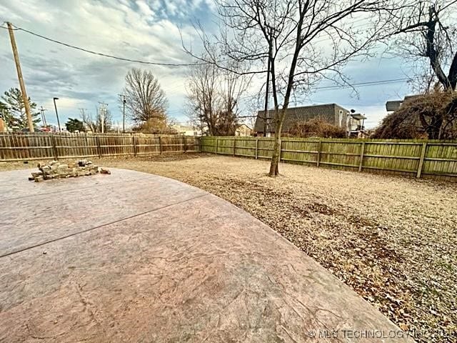 view of yard with a fenced backyard and a patio