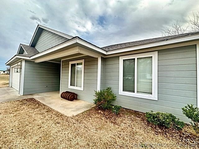 exterior space with a garage and concrete driveway