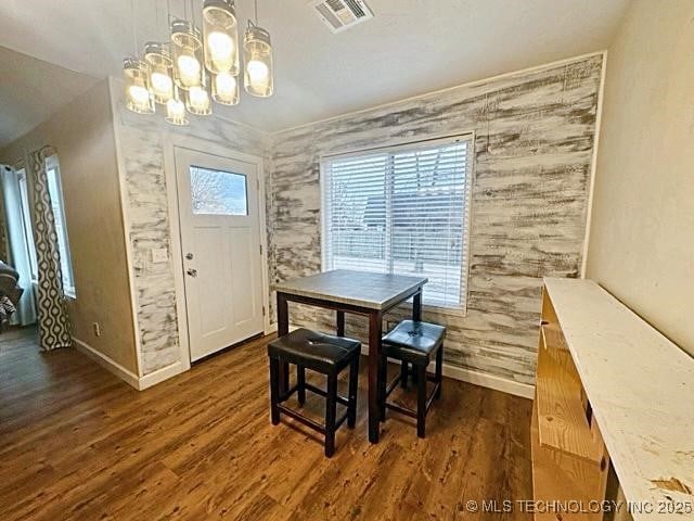 dining room featuring dark wood-type flooring, visible vents, and baseboards