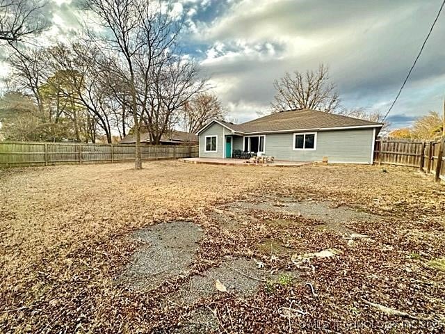 rear view of property with a fenced backyard