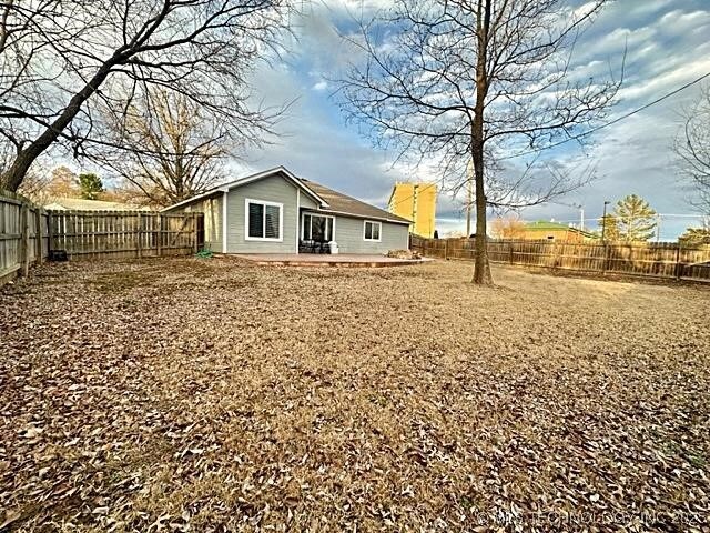 back of property with a fenced backyard